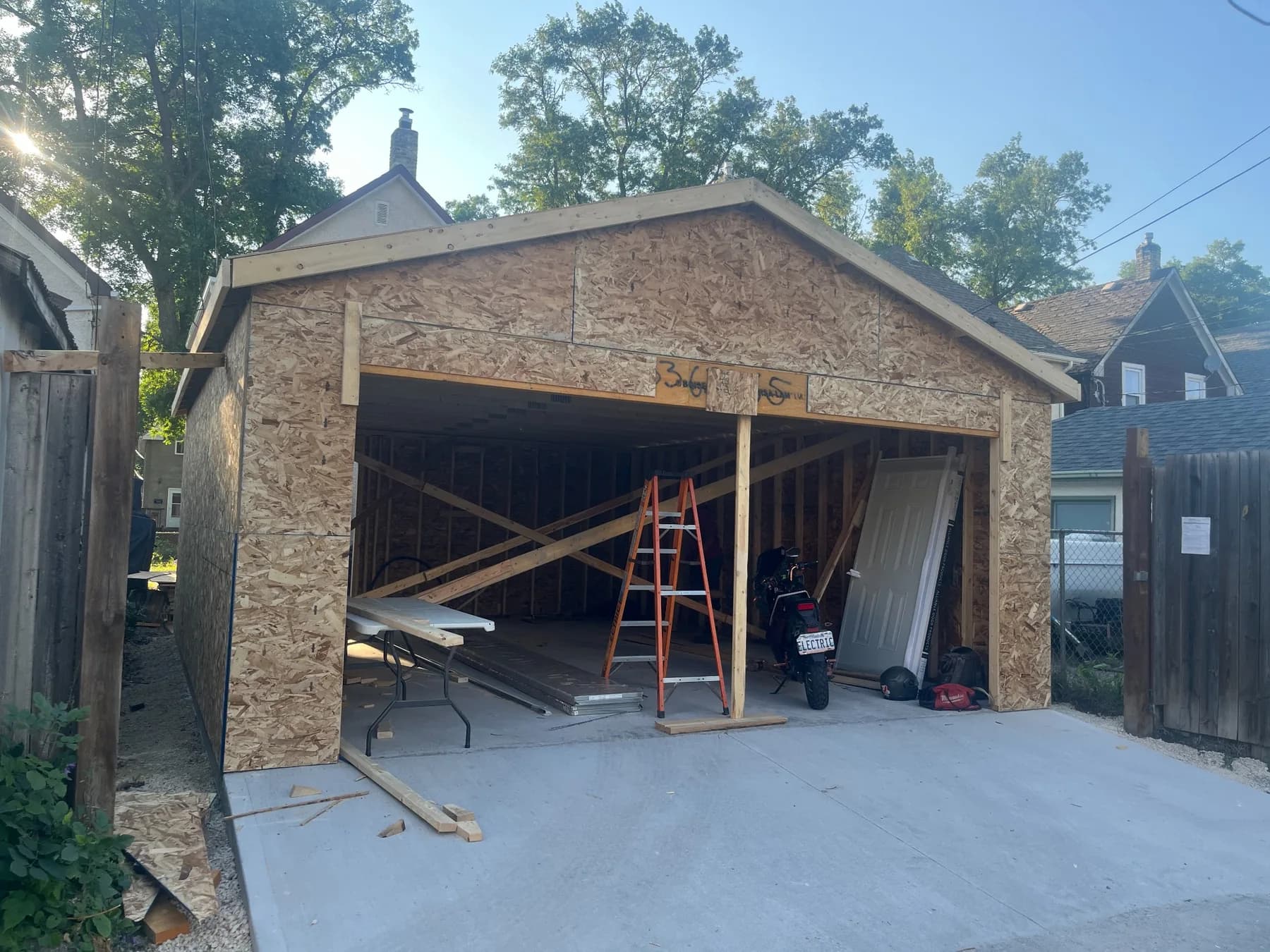 Front view of a Winnipeg detached garage during structural framing and sheathing