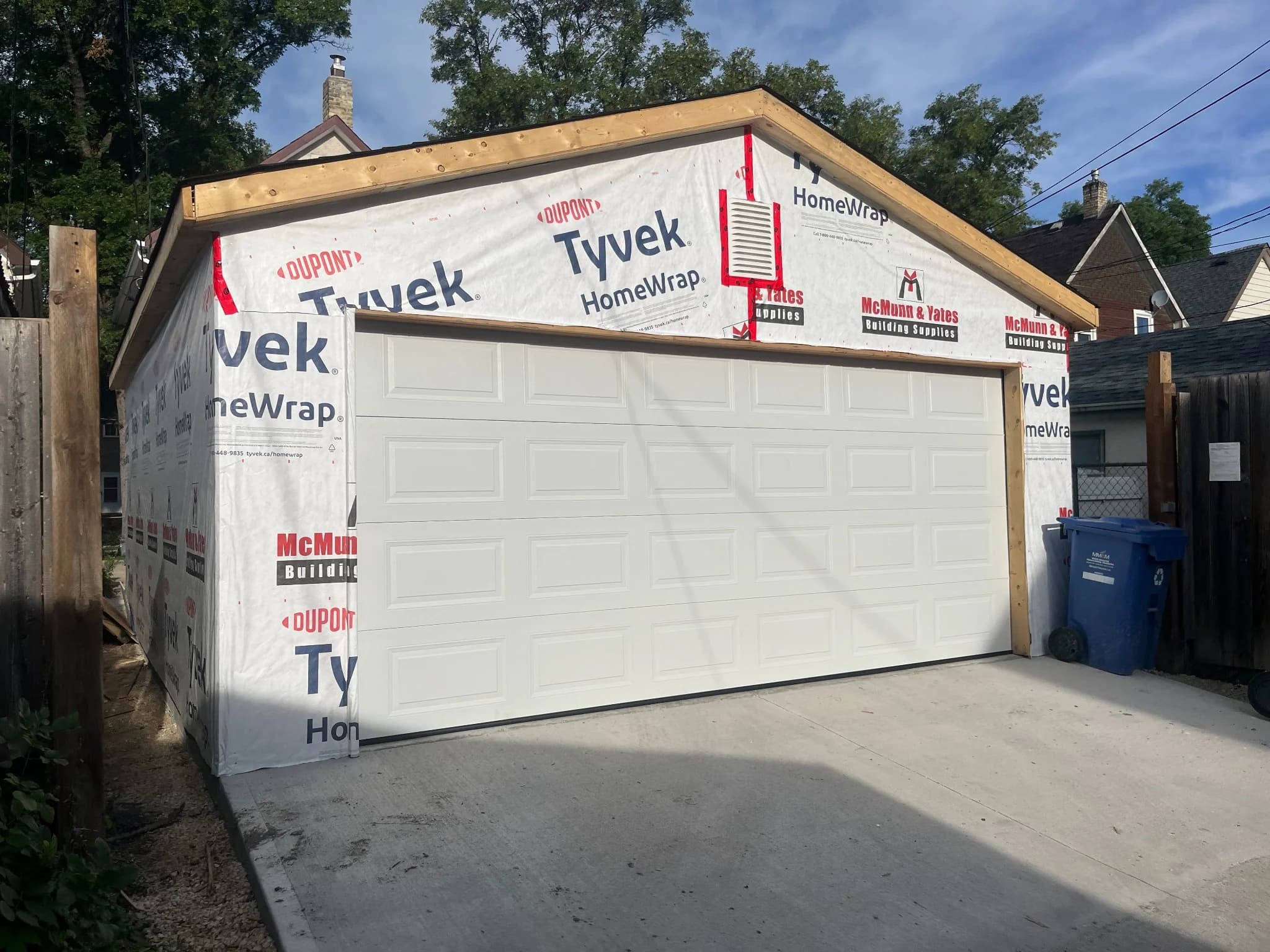 Winnipeg detached garage with overhead door installed and Tyvek house wrap on the exterior walls