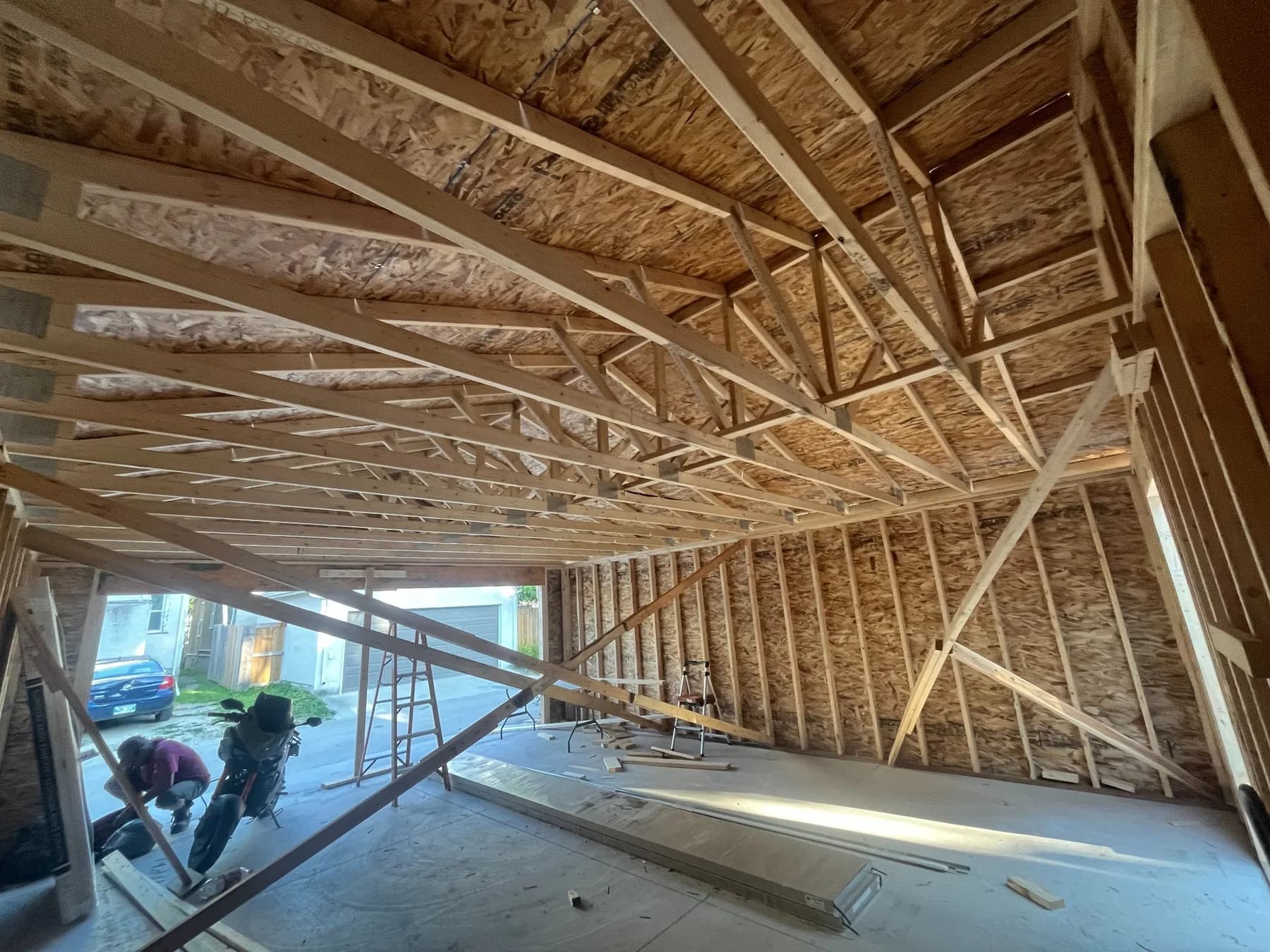 Interior view of roof trusses and wall framing inside a detached garage in Winnipeg
